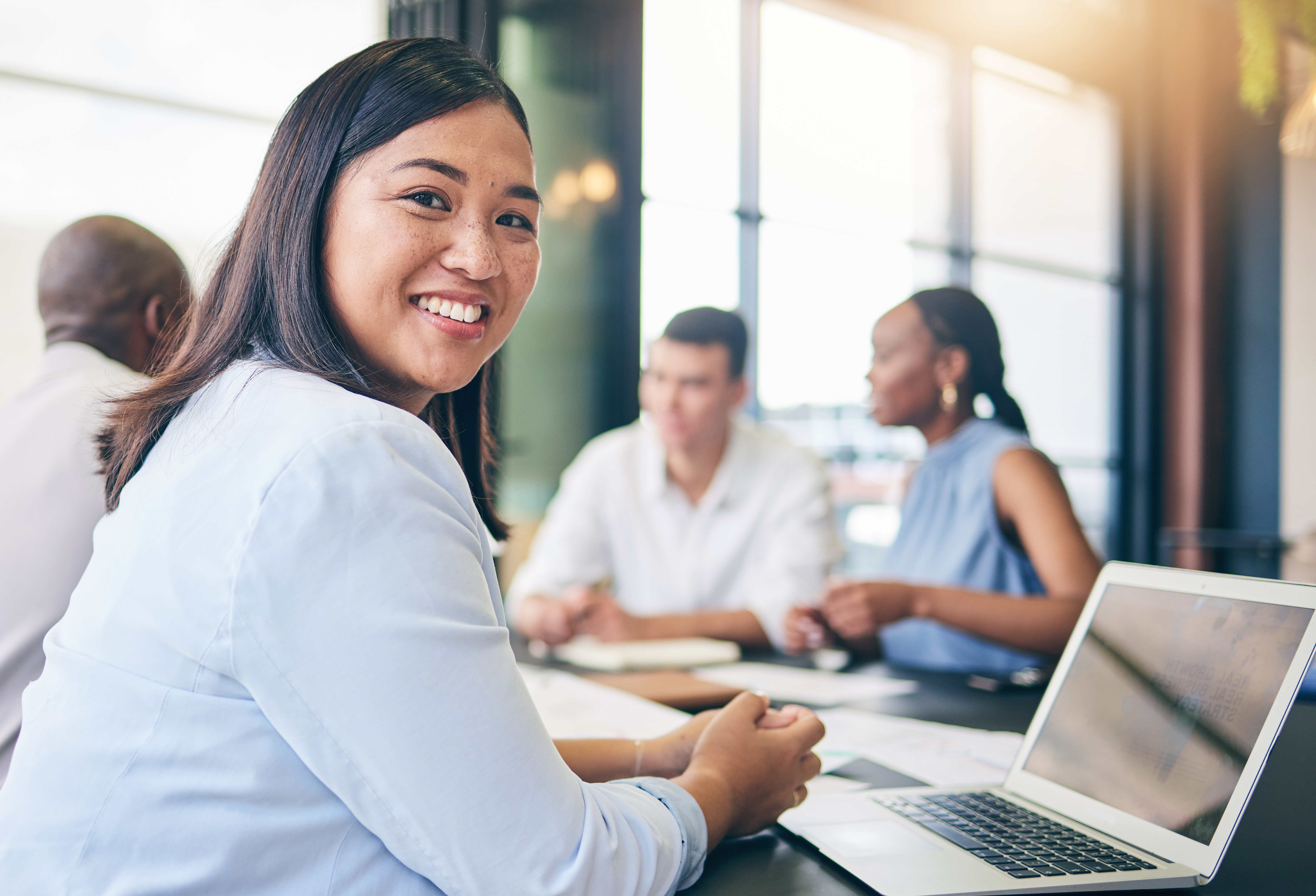 Woman smiling at business meeting Woman smiling at business meeting