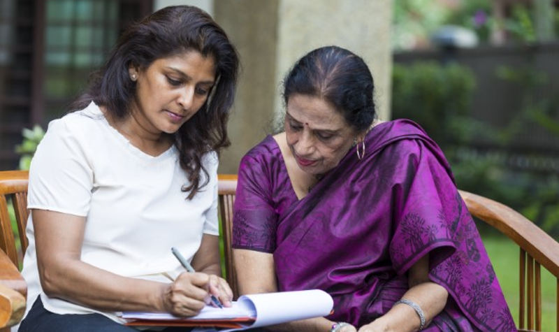 Mother and Adult Daughter Completing Forms Mother and Adult Daughter Completing Forms
