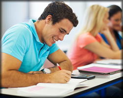 A man writing at a desk.
