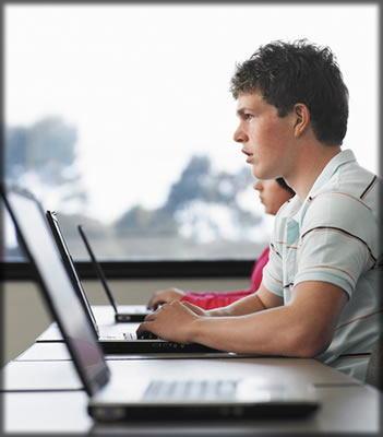 A man sitting at a laptop.