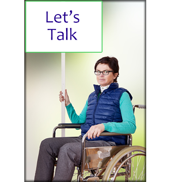 A woman in a wheelchair holding a sign that says "Let's Talk".