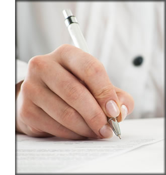 A close up of a hand writing with a pen.