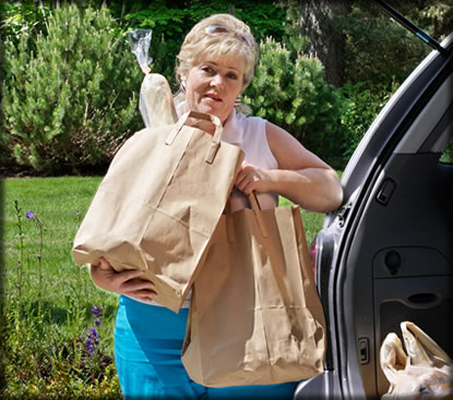 A woman carrying grocery bags.