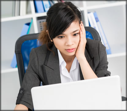 Woman sitting at laptop.