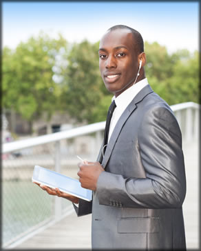 Man holding a tablet and wearing headphones.