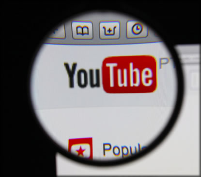 Magnifying glassed showing the Youtube logo.