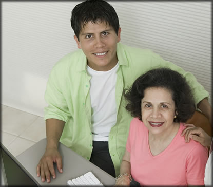 Man and woman sitting at computer.