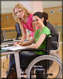 A woman standing next to a woman in a wheelchair who is smiling.