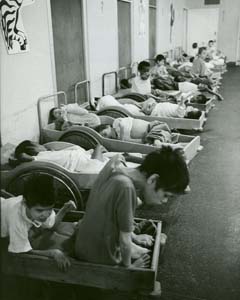 Row of children in beds