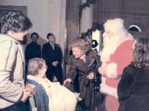 Betty Ford and Santa Claus meet child