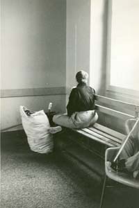 Resident alone on bench by window