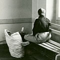Resident alone on bench by window