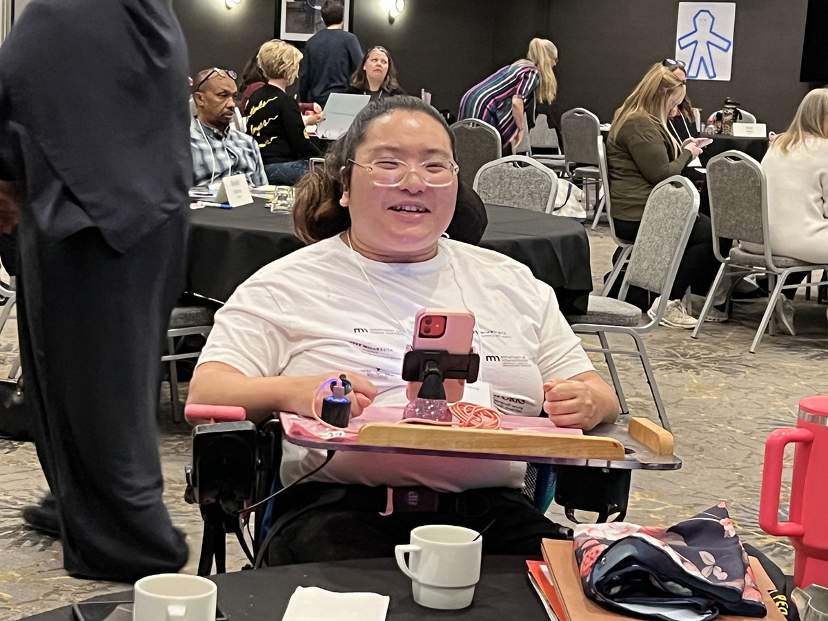 Class 42 September Session participant using wheelchair smiling